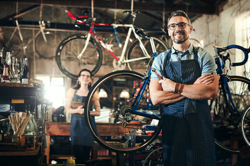 Man, portrait and arms crossed in bicycle repair shop for work in maintenance garage. Bike, mature...