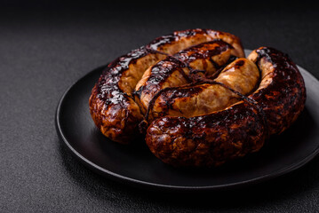 Delicious grilled sausage in the form of a ring with salt, spices