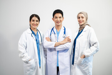 Fototapeta premium Successful team of medical doctors looking at camera and smiling while standin. Health, professional and people team.