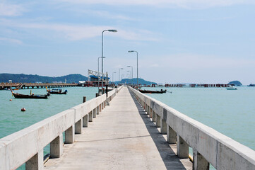 Obraz premium Beautiful landscape with conrete pier on the sea shore. Chalong Phuket Thailand.