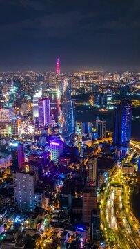 Vertical video, Hyperlapse Aerial view of beautiful night traffic and city lights in Ho Chi Minh City, Vietnam.	
