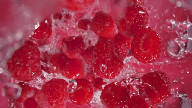 Super Slow Motion Shot of Raspberries Followed by Camera Splashing into Water at 1000 fps.