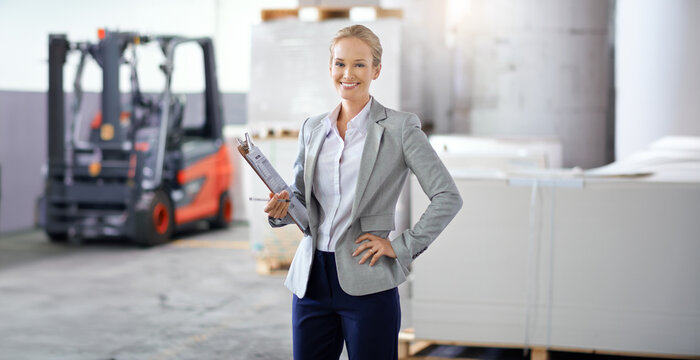Documents, factory and inspection with portrait of woman in suit for business, logistics or shipping. Clipboard, smile and quality control with supervisor in warehouse for supply chain management