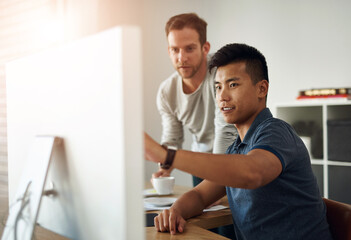 Designer, men and computer at table for feedback, development and collaboration in office....