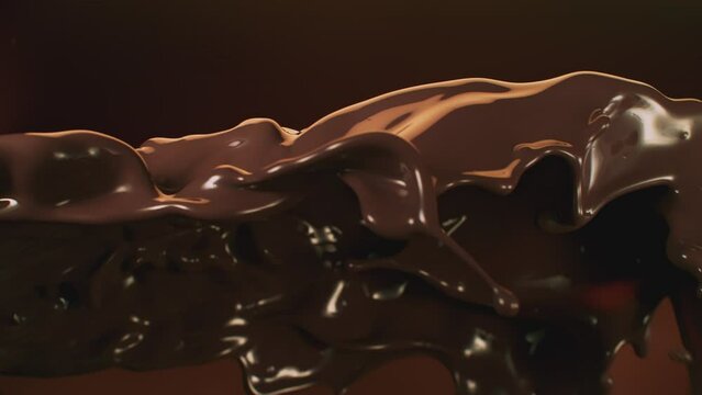 Super Slow Motion Shot of Flying Chocolate Splash on Brown Abstract Background at 1000 fps.