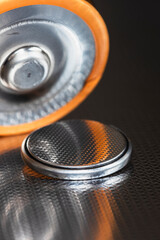 Flat lithium button cell and alkaline batteries close-up