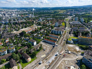 Aerial view of Swiss City of Zürich north part with highway enclosure construction site and public park on a sunny spring morning. Photo taken June 16th, 2024, Zurich, Switzerland.