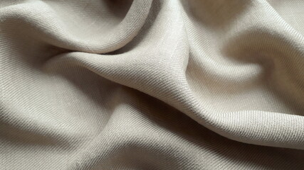 Mixed summer fabric linen and viscose in beige color. Texture of natural fabric. Textile background.