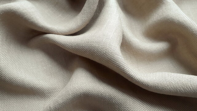 Mixed summer fabric linen and viscose in beige color. Texture of natural fabric. Textile background.