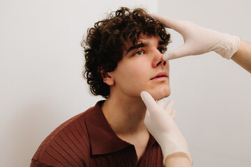 Palpation of the nasal septum. Preparation to septoplasty surgery. ENT doctor examine nose of male...