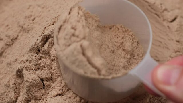 Take out a measuring spoon filled with chocolate protein powder