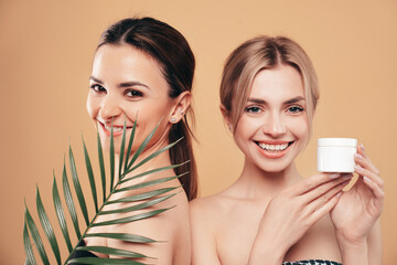 Two amazing gorgeous beautiful blonde and brunette women. Smiling models posing naked. Female...