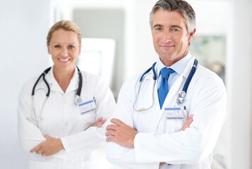 Portrait, medical team and happy in lobby for healthcare, professional and pride in hospital. Mature doctors, support and about us in corridor for cardiology, medicare and expertise in clinic