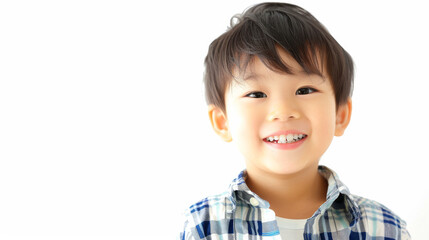 A beaming child with a missing front tooth stands against a white background, showcasing an infectious smile.