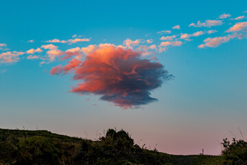 Windswept cloud during a pink sunrise in Patagonia