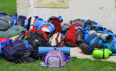 pile of backpacks and sleeping bags belonging to young adventurous backpackers