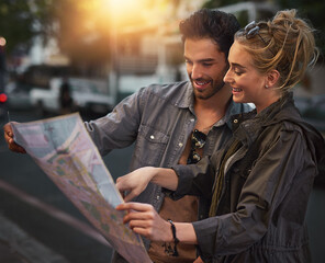 City, couple and map for reading, search and location navigation in evening in London. Dating people, man and woman with paper for guidance, hotel direction and instructions for vacation together