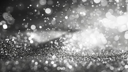 A close-up shot of a black and white glitter background with bokeh lights