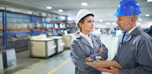 Factory, people and checklist conversation with clipboard for quality inspection or logistics planning for process. Management, talking and document for manufacturing in warehouse with collaboration