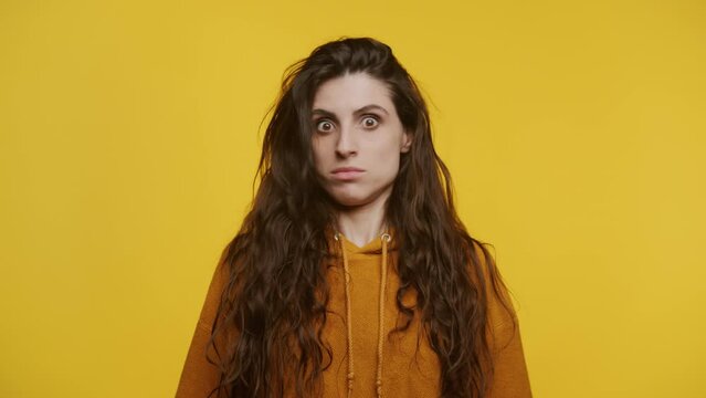 Woman Shaking Head in Disapproval Gesture on Yellow