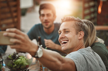 Laughing, friends and selfie of man at dinner party for celebration at social gathering. Food, picture and group of people eating lunch together at event, reunion and excited for happy memory at home