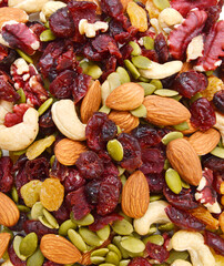 Mix nuts, dry fruits and grapes on a white background