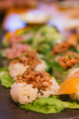 Sushi pieces served over cabbage leafs are a sought meal in restaurants all around Tokyo.