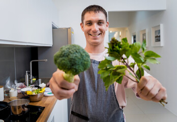 Chef at the kitchen preparing green curry with herbs and rice