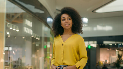 African American woman walking shopping mall store boutique black friday shopaholic client customer...