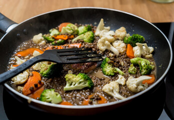 Chef at the kitchen preparing japanese buckwheat pasta with lentils