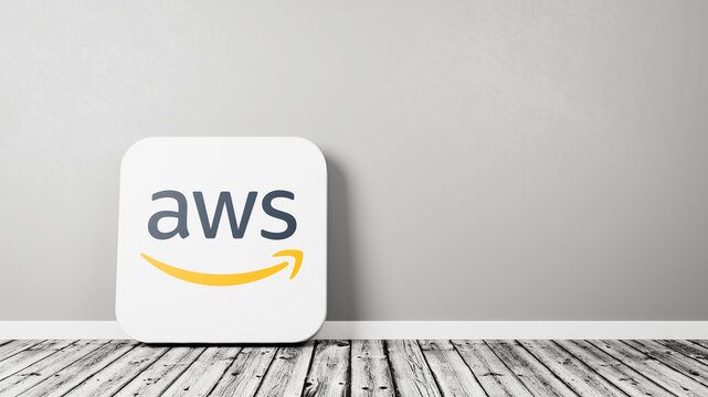 AWS, Amazon Web Services App Icon on Wooden Floor Against Wall