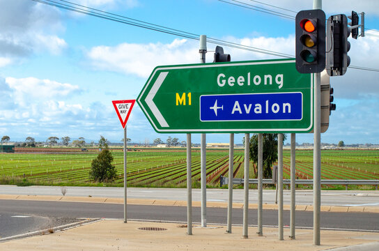 Road sign on M1 Highway with directional arrows for Geelong and Avalon Airport.