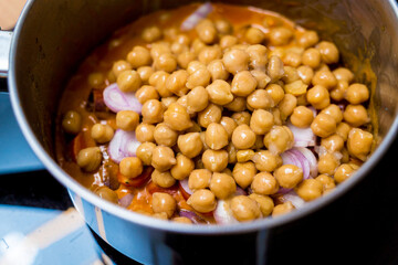 Chef at the kitchen preparing massaman curry with sweet potato and many spices