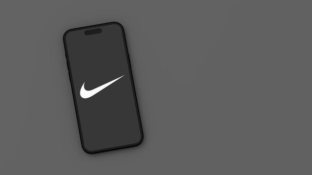 Nike Logo on Mobile Phone Screen on Gray Background with Copy Space