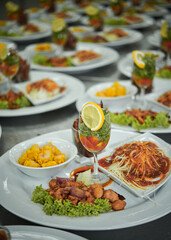 Many plates of catering food for an event.