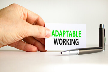 Adaptable working symbol. Concept words Adaptable working on beautiful white paper. Beautiful white background. Businessman hand. Business Adaptable working concept. Copy space.