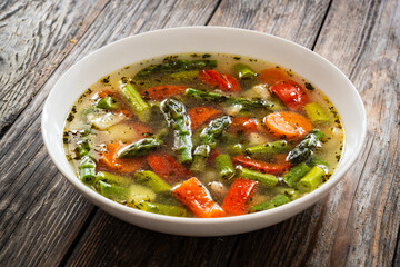 Asparagus soup on wooden table