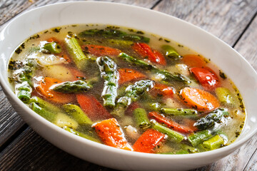 Asparagus soup on wooden table