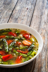 Asparagus soup on wooden table