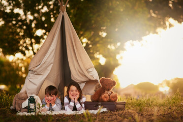 Teepee, children and fun in garden tent outdoor in nature for camping, playing and adventure with...