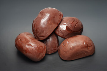 Chocolate candies. Melting chocolate candies on a dark