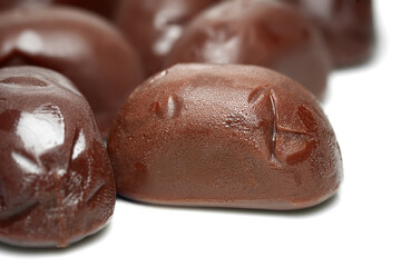 Chocolate candies. A bunch of melting chocolate candies close-up on a white