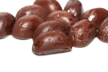 Chocolate candies. A pile of melting chocolate candies on a white