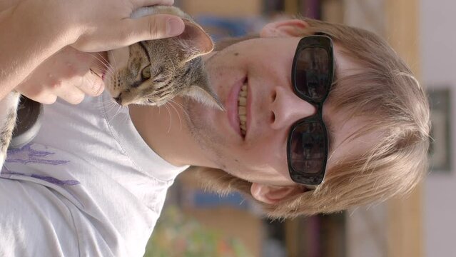 Portrait of young man holding cat in hands. Unique bond between humans and pets, moments of genuine connection and solace. deep connection shares with four-legged friend.