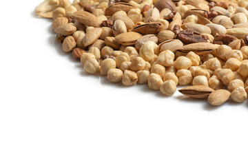 assorted nuts and seeds on white background: walnuts, almonds, hazelnuts, cashews, pistachios