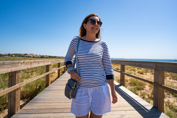 Beautiful woman walking on seaside promenade - Portugal, Algarve, Lagos  © Jacek Chabraszewski