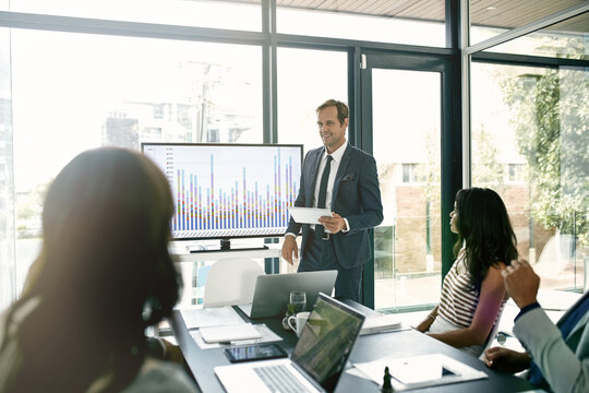 Businessman, discussion and presentation with data on screen for hr metrics review, insights and planning. Leader, people and human resource analytics for employee performance and profit management.