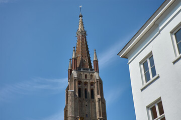 Fototapeta premium Street view at the Church of Our Lady in the medieval old town of Bruges, Belgium.