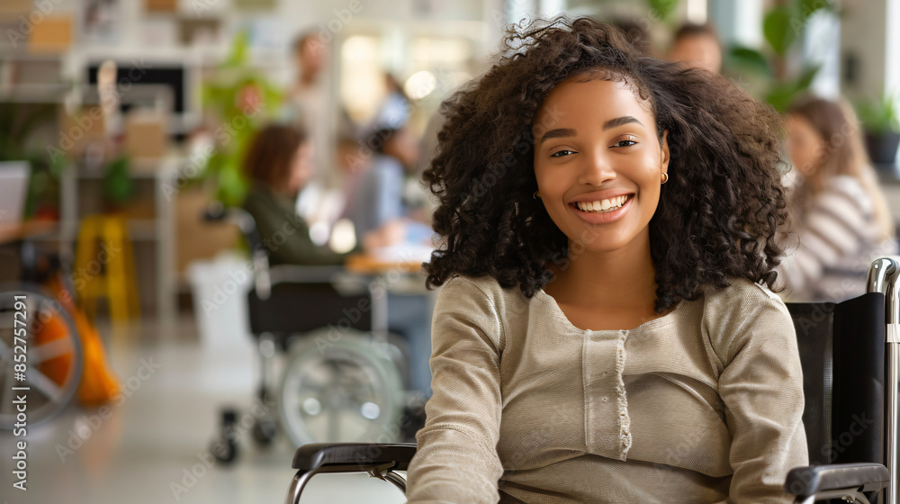 Wall mural Smiling young female professional in a wheelchair posing in a modern work environment