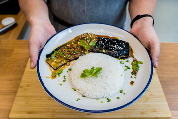 Delicious grilled eggplants with garlic on the white plate